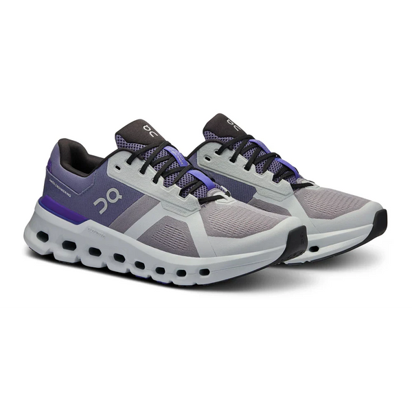 A pair of men's on running shoes with black shoe laces adn a indigo lace protector.