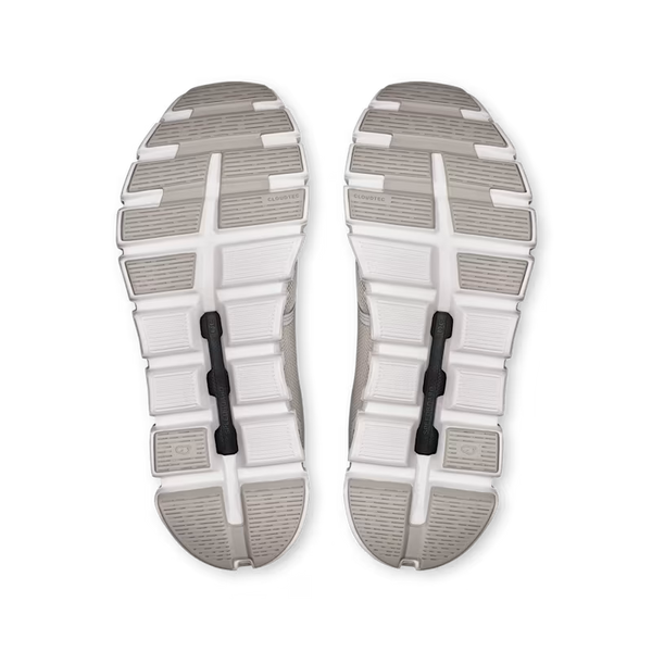 Top view of a pair of gray and white athletic shoes on a white background
