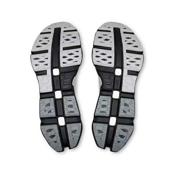 A pair of athletic shoes shown from the sole view, featuring a textured gray and black tread pattern on a clean white background.
