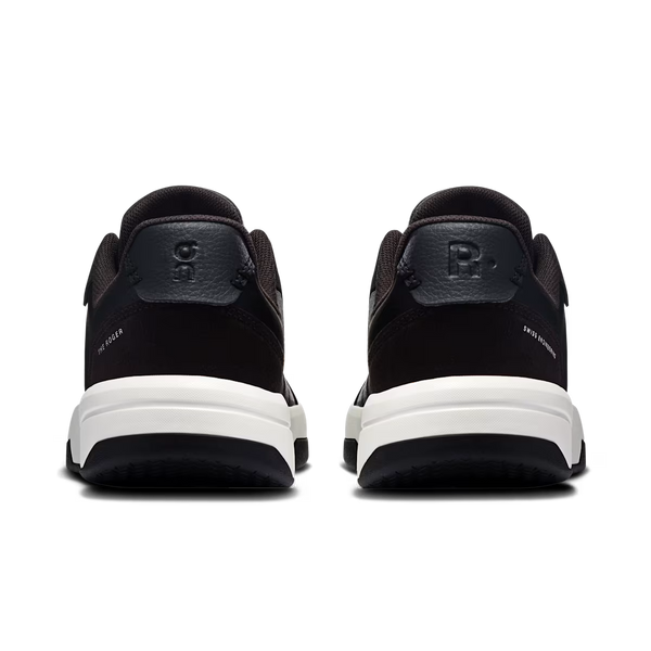 A pair of black sneakers shown from the back, featuring a thick white midsole and a black heel tab with a debossed letter 'P'.