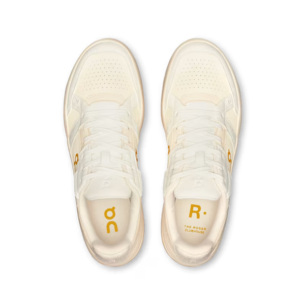 Pair of cream-colored sneakers with brand logos on a white background
