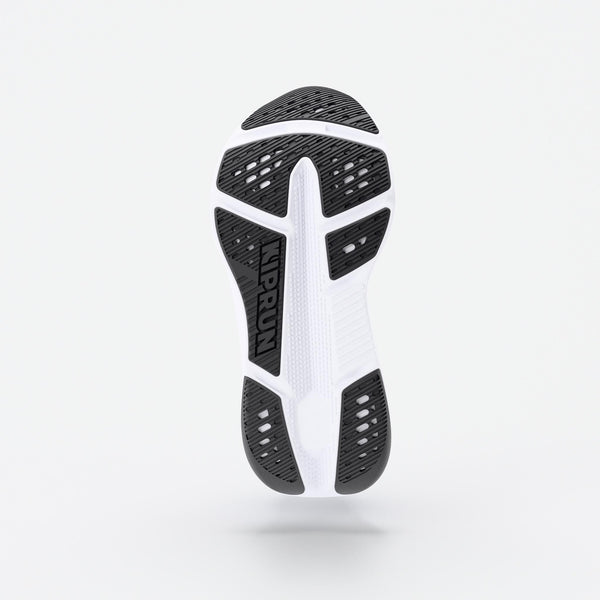 Close-up of a shoe sole with a white and black design on a light gray background