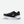Black running shoe with white sole on a light gray background