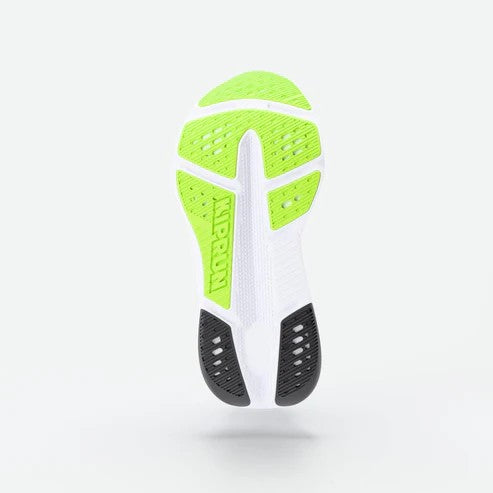 Close-up of a shoe sole with green, white, and black design on a light gray background