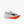 White running shoe with orange sole on a white background