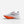 White running shoe with orange sole on a white background