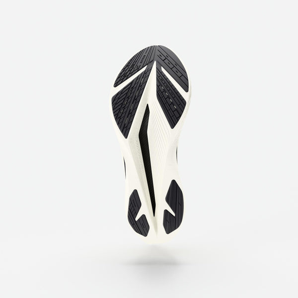 Close-up of a shoe sole with black and white design on a light gray background