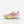 Pink running shoe with green sole on a white background