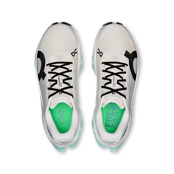 A top down look at a women's on running shoe with black shoe lces adn a black On logo on the outside of each shoe.