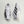 White and black Adidas running shoes on a light gray background