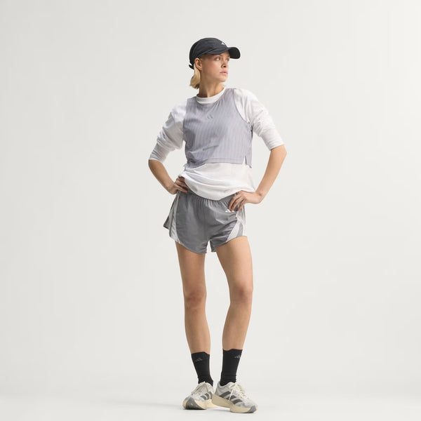 A women wearing a top to bottom adidas running outfit.