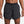 Black Nike running shorts on a person against a plain background