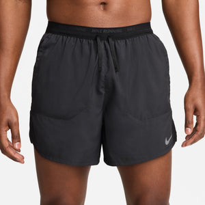 Black Nike running shorts on a person against a plain background