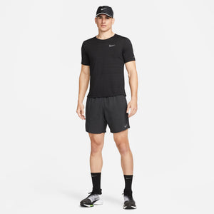 Man wearing a black Nike athletic outfit on a white background