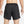 Black Nike running shorts on a person against a light gray background