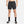 Person wearing black athletic shorts and socks on a white background