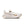 This women's Nike shoe is mostly all white with a few hits of gold.