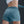 Person wearing teal athletic shorts on a dark background