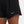 Black shorts with a Nike logo on a white background
