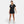 Woman wearing a black Nike t-shirt and shorts on a white background