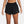 Black Nike shorts worn by a person on a white background