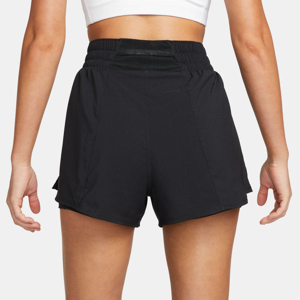 Black athletic shorts worn by a person on a white background
