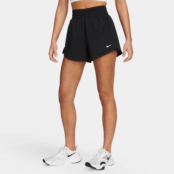 Person wearing black athletic shorts with a brand logo on a white background