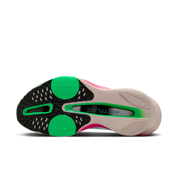 Close-up of a shoe sole with green and pink accents on a white background.