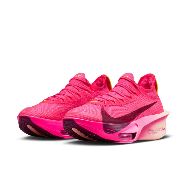Pink athletic shoes with a Nike logo on a white background