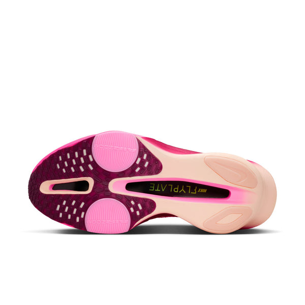 Pink and beige athletic shoe sole on a white background