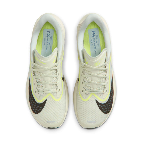 Pair of white sneakers with black and yellow accents on a white background