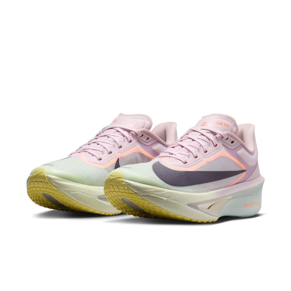 Pair of pink and yellow running shoes on a white background