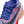 Gray and blue sneaker with red accents on a white background