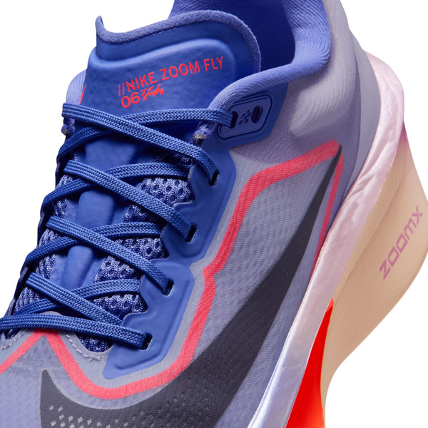 Gray and blue sneaker with red accents on a white background