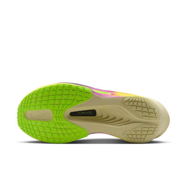 Close-up of a shoe's sole with green and beige color on a white background.
