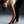 Woman in athletic wear preparing to run on a gradient background