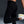 Person wearing black athletic leggings with a Nike logo on a dark background