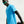 Person wearing a blue athletic shirt and black arm sleeve on a light gray background