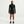 Person wearing a black athletic outfit on a white background
