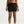 Person wearing black athletic shorts with a Nike logo on a white background