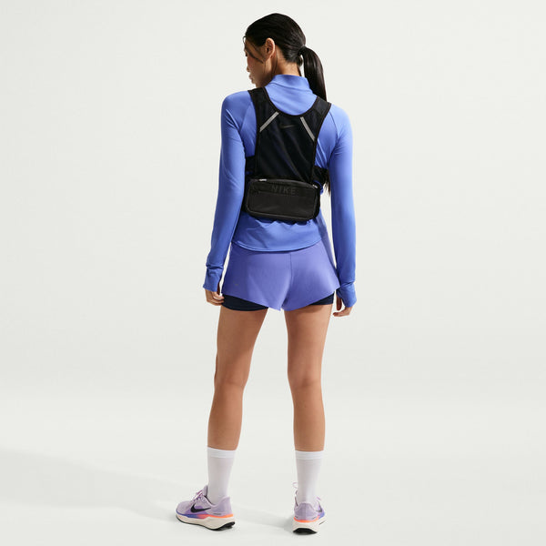 Person wearing a blue athletic outfit with a black backpack on a white background