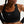 Person wearing a black Nike sports bra against a neutral background