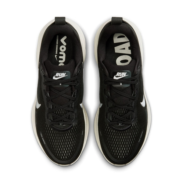 Nike black and white running shoes with white soles on a white background.