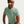 Person wearing a light green Nike t-shirt on a plain background