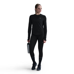 Person wearing a black Nike outfit on a white background