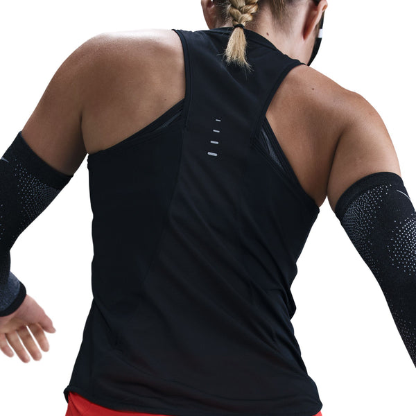 Person wearing a black sleeveless athletic top with visible branding on a white background