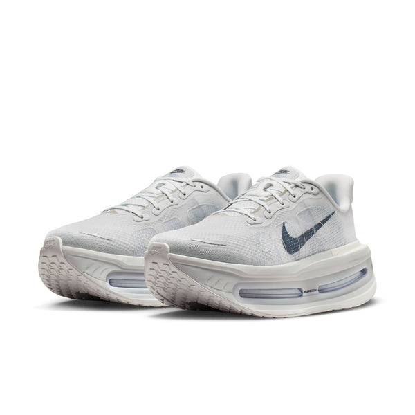 A pair of light grey and white Nike Vomero Premium running shoes.