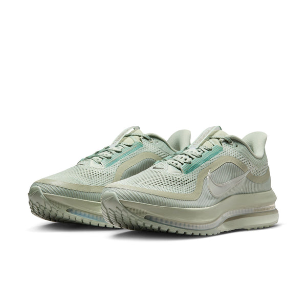 Pair of light gray running shoes with a Nike logo on a white background.