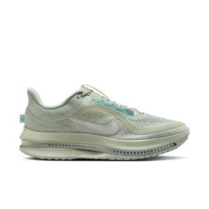 Light green running shoe with Nike logo on a white background.