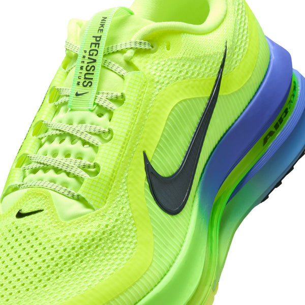 Neon green running shoe with blue sole on a white background